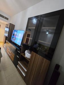 a living room with a large mirror and a television at النزهة2 in Cairo