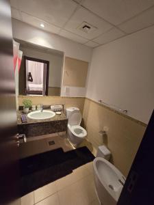 a bathroom with a sink and a toilet and a sink at النزهة2 in Cairo +1 photo