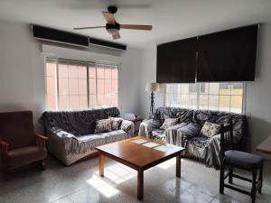 a living room with two couches and a coffee table at La Casa de los Alemanes in Gaibiel