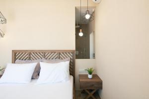 A bed or beds in a room at Seafront elegant villas, with infinity pools & devine views!