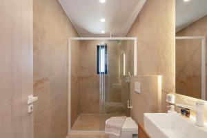 A bathroom at Seafront elegant villas, with infinity pools & devine views!