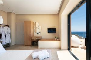 A television and/or entertainment centre at Seafront elegant villas, with infinity pools & devine views!