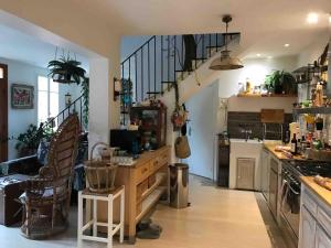 a kitchen with a staircase and a living room at Maison de ville avec jardin in Nice