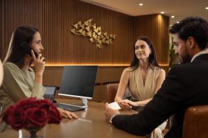 a group of people sitting around a table in a room at Golden Sands Suites in Dubai
