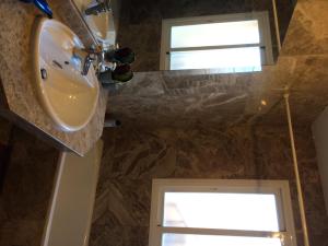 a bathroom with a sink and a window at La Galera Park House in Estepona