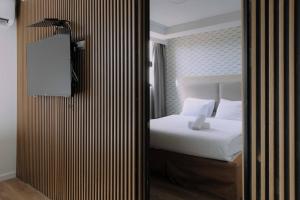 Rúm í herbergi á Rich Boutique Hotel