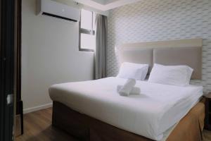 Rúm í herbergi á Rich Boutique Hotel