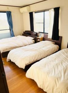 Postel nebo postele na pokoji v ubytování NAGASIMA Nagoya
