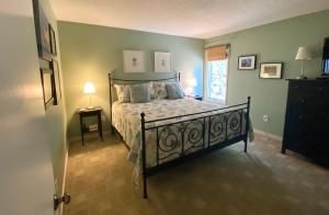 a bedroom with a bed in a room with a window at 1617 Live Oak in Johns Island +8 photos