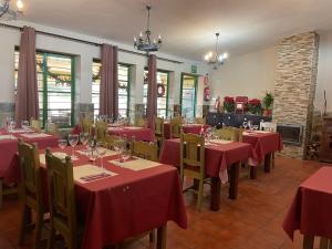 a restaurant with red tables and chairs in a room at Hotel Rural Juncalillo in Gáldar