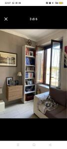a living room with a bed and a book shelf at Casa Callisto in Asti