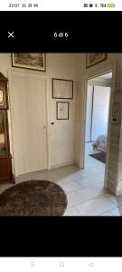 a picture of a room with a door and a rug at Casa Callisto in Asti