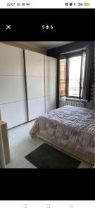 a bedroom with a bed in a room with a window at Casa Callisto in Asti