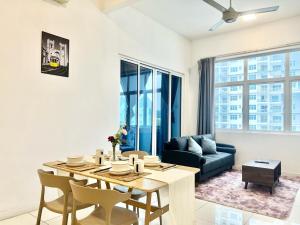 a living room with a table and a couch at SG 1-6Pax 1Room 4Bed Sky Pod Puchong IOI Mall LRT in Puchong