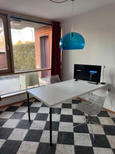 a white table in a room with a checkered floor at Terrassenwohnung mit Donaublick 4 in Neu Ulm