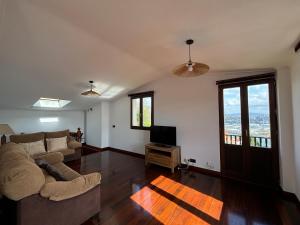 a living room with a couch and a tv at Casa Martorell Ferrol in Ferrol