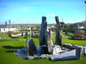 a sculpture of rocks on a golf course at Chalet 151, Perran Sands in Perranporth