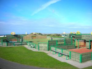 a baseball field with benches in the grass at Chalet 151, Perran Sands in Perranporth