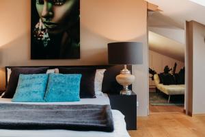 a bedroom with a bed with a painting on the wall at Loft Thaler Rooms in Bolzano +4 photos
