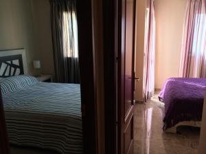 a bedroom with a bed and a window and a door at La Galera Park House in Estepona
