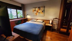a bedroom with a bed and a window at Lorena Residence - Cozy Flat with Balcony in São Paulo +22 photos