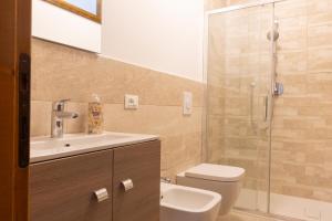 a bathroom with a toilet and a sink and a shower at Strategico per escursioni - Balcone con Vista in Gallio +25 photos