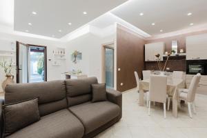 Una sala de estar con un sofá y un comedor. en Casa Scirocco Marsala, en Marsala 20 fotos más