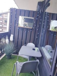 a table and chairs on a patio with a fence at Le Mazots, Balcon, Parking, Proche Pistes in Arâches-la-Frasse +12 photos