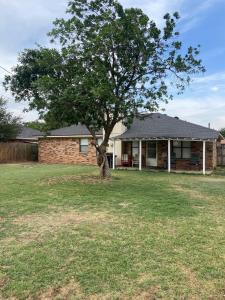 ein Baum in einem Hof vor einem Haus in der Unterkunft Cozy 3 Bedroom Home in Quiet Neighborhood in Amarillo