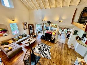 a living room with a couch and a zebra rug at Auberge de jeunesse El Poyito Kite & Surf Camp in Sainte-Anne