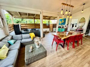 a living room with a couch and a table at Auberge de jeunesse El Poyito Kite & Surf Camp in Sainte-Anne +36 photos