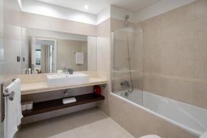 a bathroom with a sink and a tub and a shower at Amparo II by An Island Apart in Funchal