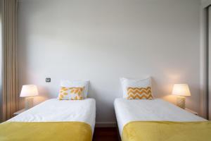 two beds sitting next to each other in a room at Amparo II by An Island Apart in Funchal