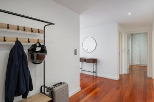 a living room with a suitcase and a mirror at Amparo II by An Island Apart in Funchal
