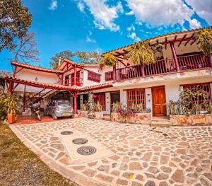 a house with a car parked in front of it at Casa Aminta in Curití