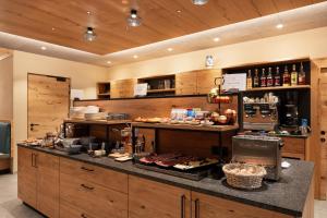 a kitchen with a counter with food on it at Residence Erika - Apartments, Breakfast & Sauna in Siusi