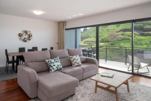 a living room with a couch and a table at Amparo II by An Island Apart in Funchal +19 photos
