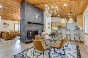 a dining room with a glass table and a fireplace at Mountain Mansion With A Hot Tub And A Sauna in Morrison