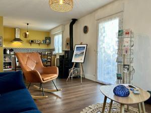a living room with a couch and a table at 1001 - Appartement T3 au cœur de Pléneuf-Val-André in Pléneuf-Val-André