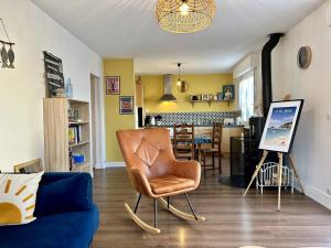 a living room with a chair and a painting at 1001 - Appartement T3 au cœur de Pléneuf-Val-André in Pléneuf-Val-André +25 photos