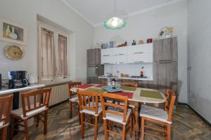 a kitchen and dining room with a table and chairs at House Montebello in Rome