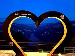 two heart shaped signs with a view of a city at Quinta Casal da Silva 1951 in Magrelos +88 photos