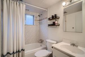 a bathroom with a toilet and a sink and a tub at Guest Suite In West Denver With A Full KItchen in Wheat Ridge