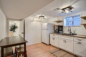a kitchen with a table and a white refrigerator at Guest Suite In West Denver With A Full KItchen in Wheat Ridge