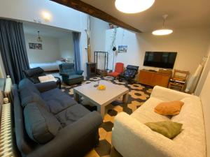 a living room with a couch and a table at Zarlar House in Geraardsbergen