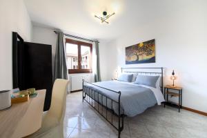 a bedroom with a bed and a tv and a desk at Orio Stay&Fly in Orio al Serio +24 photos