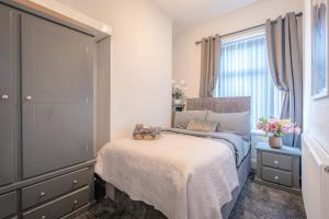 ein Schlafzimmer mit einem Bett, auf dem ein Teddybär liegt in der Unterkunft Brierfield Cottage in Brierfield