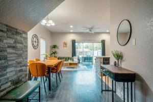 a dining room and living room with a table and chairs at Full House HotTub Mins to UCF in Bithlo