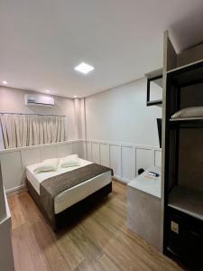 a bedroom with a bed in a room with a bunk bed at Arca's Executive Hotel in Toledo