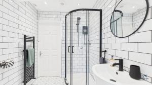 a white bathroom with a sink and a shower at Simeon Sands Coastal Escape in Ryde +22 photos
